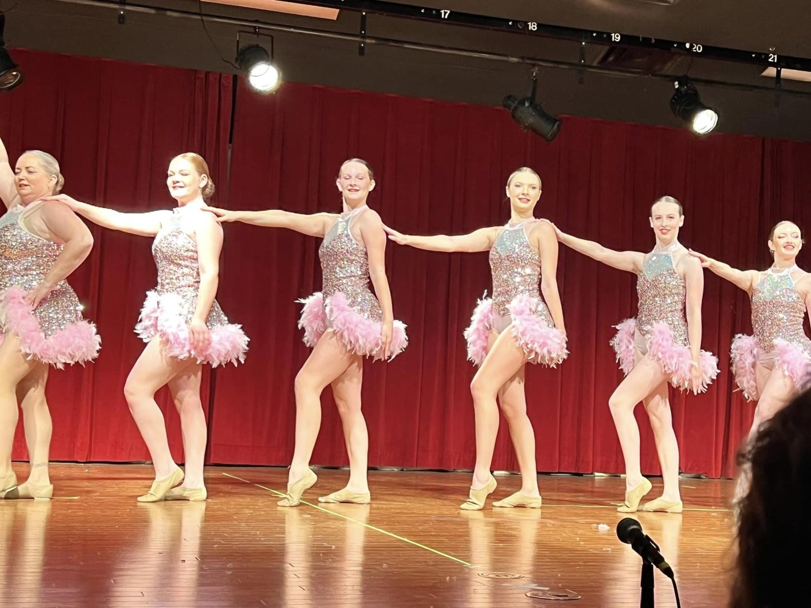 Dancers lined up across the recital stage