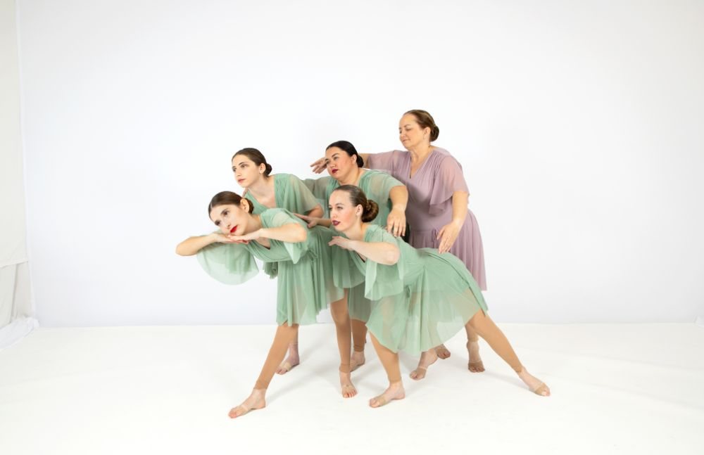 Ballet class in lavender costumes posed together