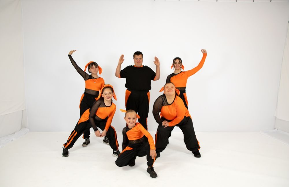 Hip hop class in orange and black costumes